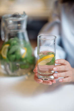 Water with fruits and herbs in a glass bowlの写真素材