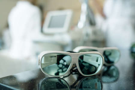 Safety glasses for laser hair removal and hardware teeth whitening procedures in a beauty salonの写真素材
