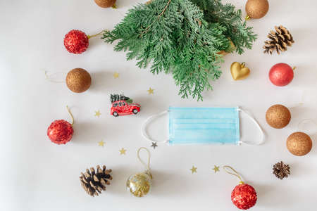 Christmas footage made of new year decorations and fir branches and face mask on a white backgroundの写真素材