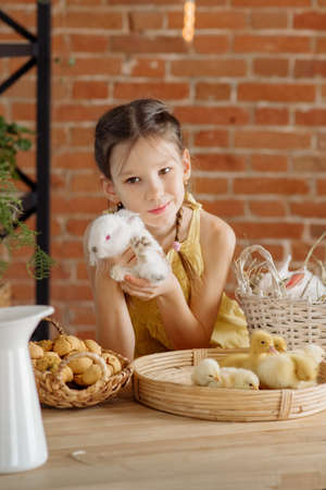 Cute girl with funny white easter bunny - easter holiday conceptの写真素材