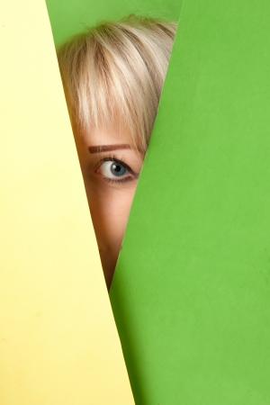 beautiful girl watching out from a colorful surroundingの写真素材