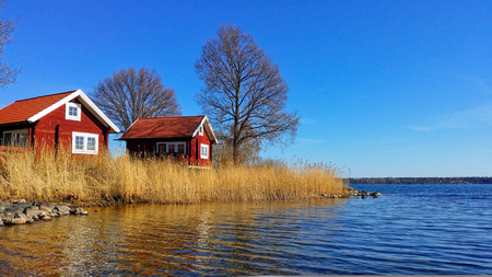 Swedish Red House on the seaside. Color of Spring of one of Swedish Archipelago.の写真素材