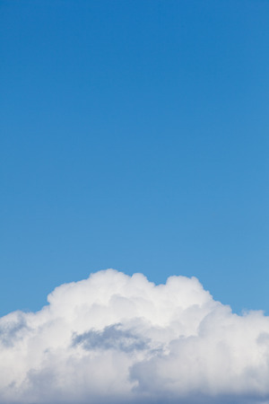 White clouds arising under blue clear sky, for backgrounds. Taken at Stockholm city center during the spring.の写真素材