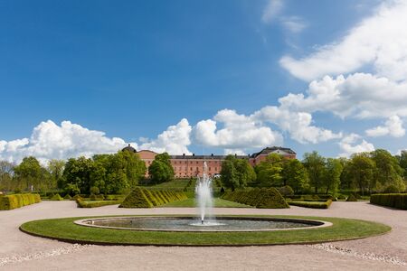 Uppsala, Sweden - May 20, 2016 : Distant view of the Uppsala Castle from the botanic garden including fountains.のeditorial素材