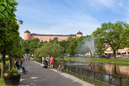 Uppsala, Sweden - Jun 1, 2016 : Swan pond against the Uppsala Castle. This pond was built in 1500s and one of the most popular promenades in the center of Uppsala City.のeditorial素材