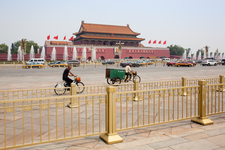 Beijing, China - Jun 20, 2016 : Scene of the Tiananmen square with cars, bicycles and the iconic golden colored fences.のeditorial素材