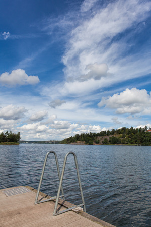 Scenic view of Swedish lake during summer under beautiful blue sky.の写真素材