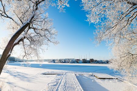 Frozen sea and snow covered Stockholm during the winterの写真素材