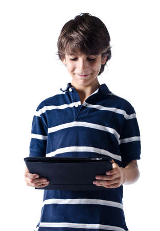 Young boy standing using tablet computer. Isolated on whiteの写真素材