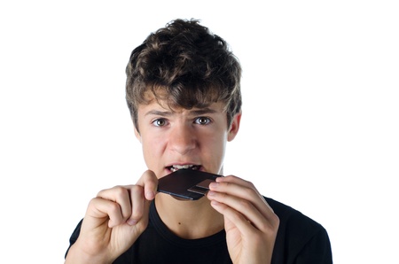 teen boy confused puzzled by floppy disk isolated on white