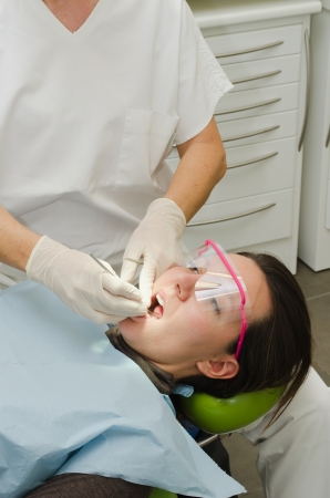 Hands of female dentist working on patientの写真素材
