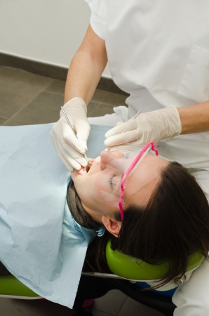 Hands of female dentist working on patientの写真素材