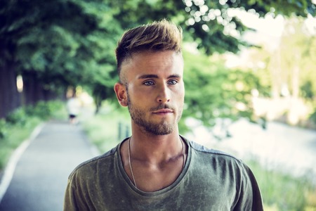 Good looking, blue eyed male model relaxing in nature, walking, looking to a sideの写真素材