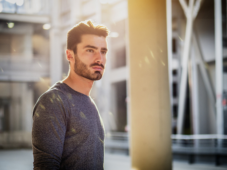 Attractive young bearded man portrait in urban environmentの写真素材