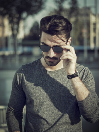 Attractive young bearded man portrait in urban environmentの写真素材
