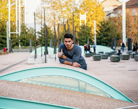Attractive young bearded man portrait in urban setting, looking at cameraの写真素材