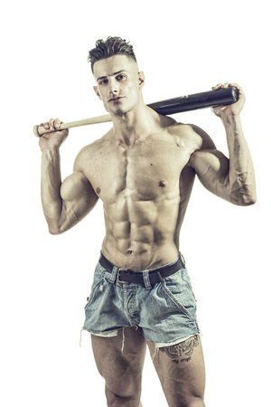 Young topless sexual man posing with bat and baseball isolated on white background.の写真素材