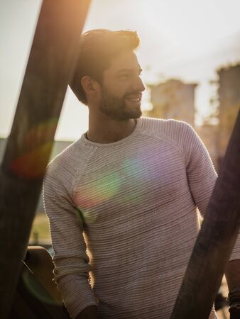 One handsome young man in urban setting in European city, standing