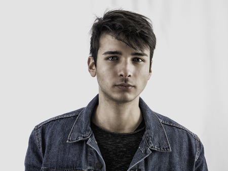 Close-up of handsome young man or teenager in studio