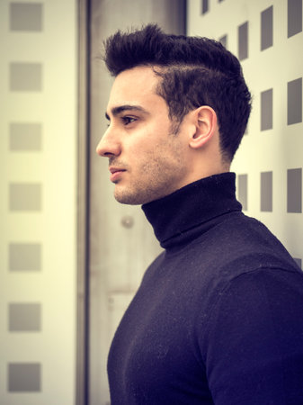 One handsome young man in urban setting in moden city