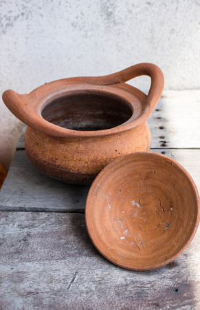Clay pot on wooden table inside the house.の写真素材