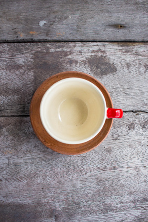 Coffee cup placed on the wooden floor.の写真素材