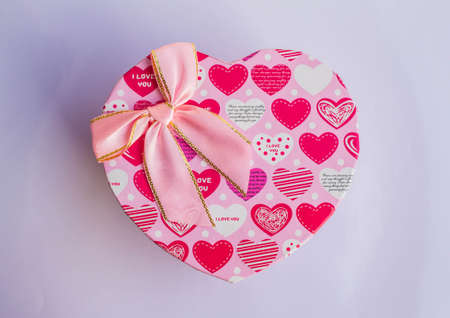 Pink heart shaped gift box on a white background.の写真素材