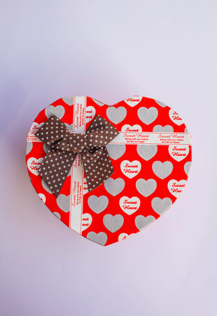 Red heart shaped gift box on a white background.の写真素材
