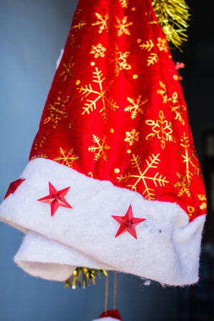 Santa hats hanging on the Cross at Christmasの写真素材