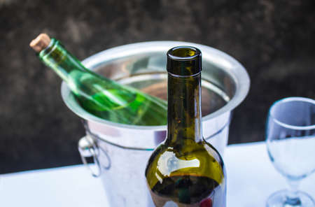 Bottle and glass of wine on the table at the party.の写真素材