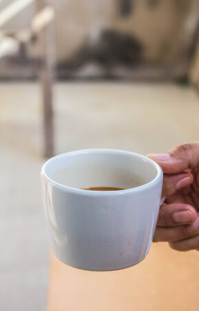 Are holding a Are holding a coffee cup in hand.の写真素材
