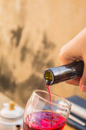 Red wine being poured into a glassの写真素材