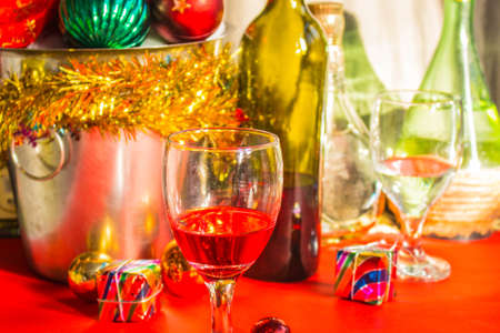 glass of wine and gifts on the tableの写真素材