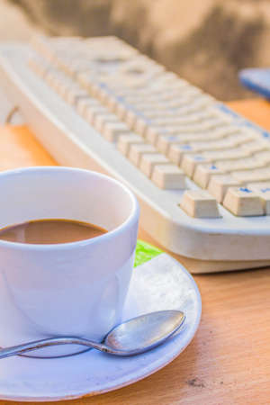 Cup of coffee and keyboardsの写真素材