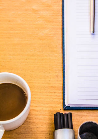 Coffee and pencil on the tableの写真素材