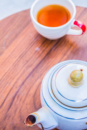 Put the teapot on the table.の写真素材