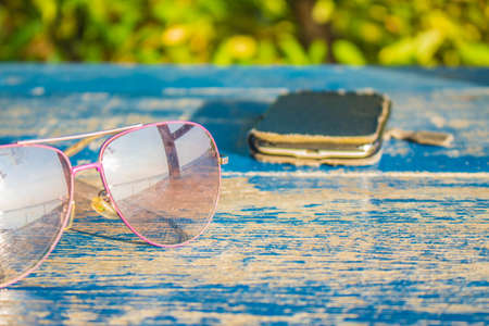 Glasses and cell phones on the wooden floor.の写真素材