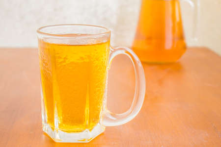Chilled beer on a wooden table.の写真素材