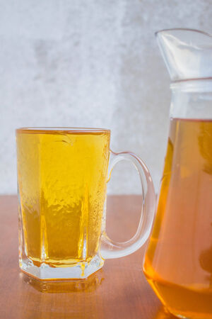 Chilled glass beer mug beside the wooden floor.の写真素材