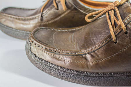 Brown leather boots on the ground look close.の写真素材