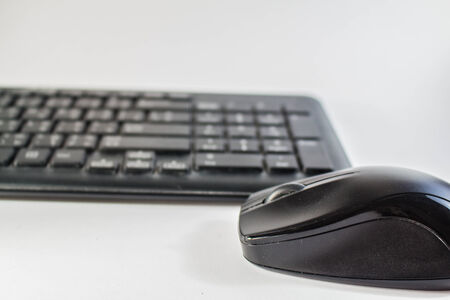 The wireless mouse is placed above the keyboard.の写真素材