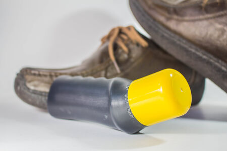 Shoe polish bottles placed in front.の写真素材