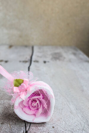 Souvenirs pink heart on the woodenの写真素材