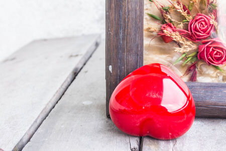 Red heart and frame on a woodenの写真素材