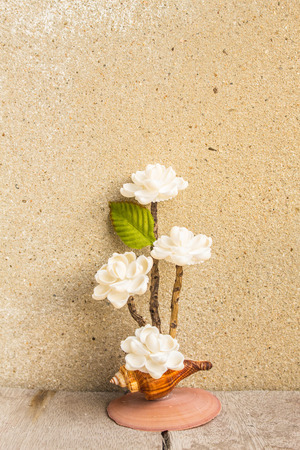 Artificial flowers made of shells on the woodenの写真素材