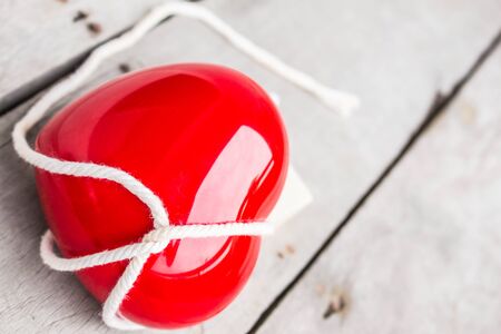 Heart red tie on a wooden table.の写真素材