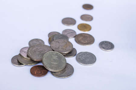 Coins of various currencies on white backgroundの写真素材