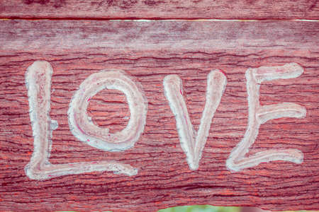Letters of love carved on wood.の写真素材