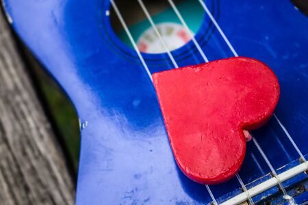 Red heart on the line of guitar.の写真素材