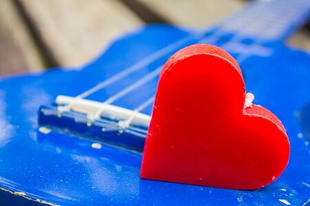 Heart on blue wooden ukulele.の写真素材